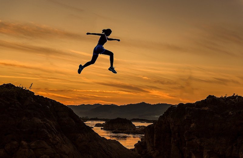 Leap of Faith Leap of faith. Person leaping with the sunset in the background
